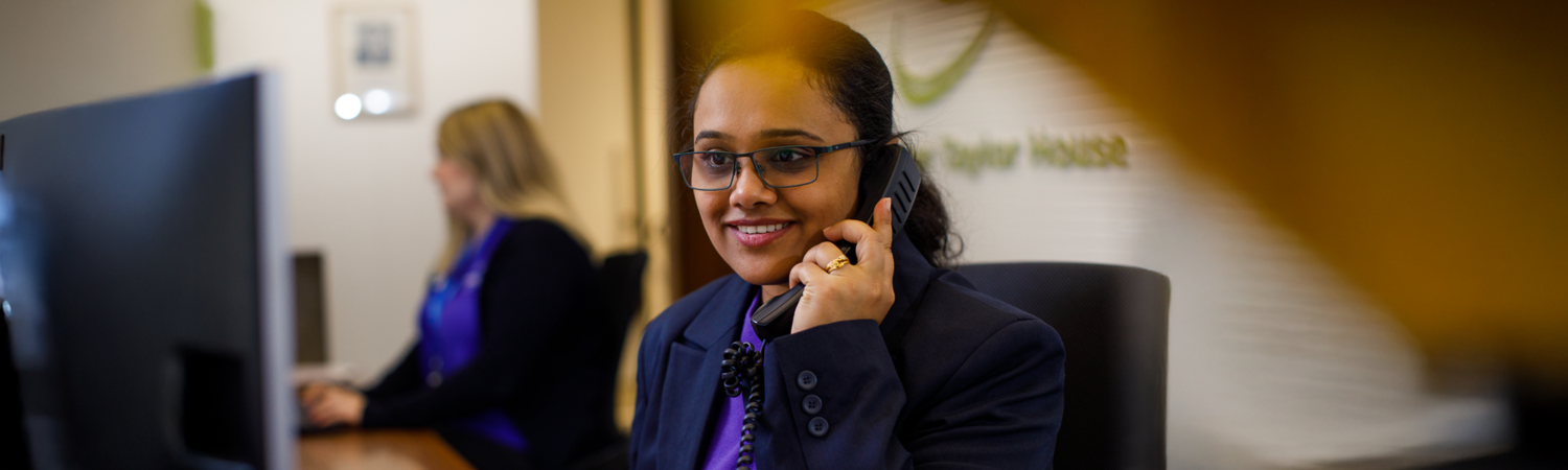 Adult, Female, Person, Woman, Face, Head, Smile, Suit, Monitor, Finger