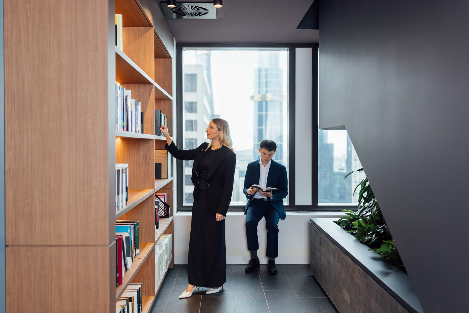 Adult, Female, Person, Woman, Furniture, Indoors, Interior Design, Bookcase, Formal Wear, Suit