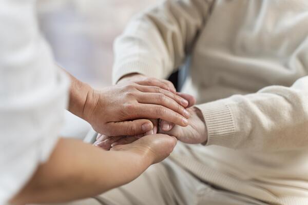doctor-holding-hands-with-senior-patient.jpg