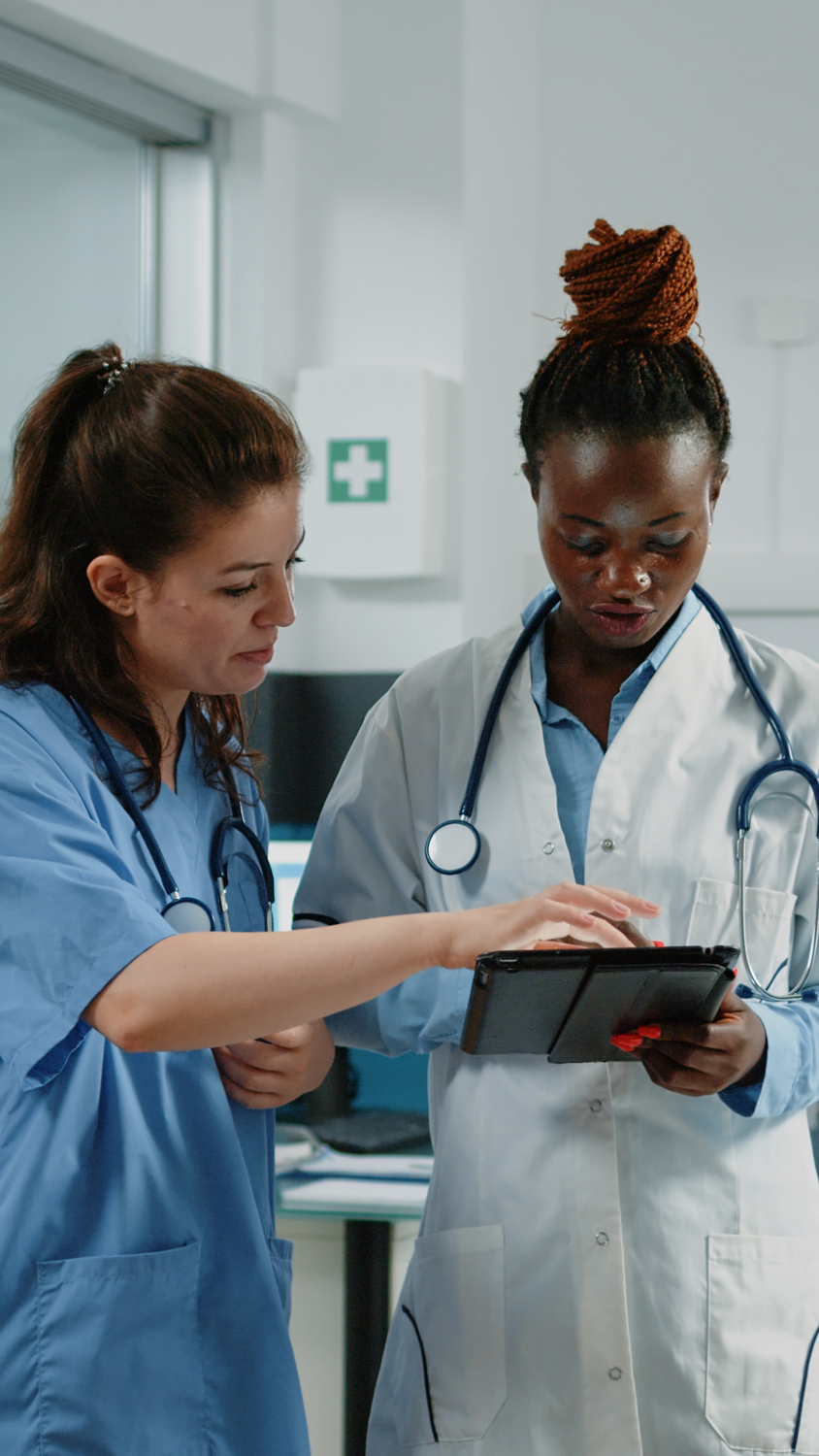 Person, Electronics, Tablet Computer, Face, Head, Clothing, Coat, Building, Hospital, First Aid